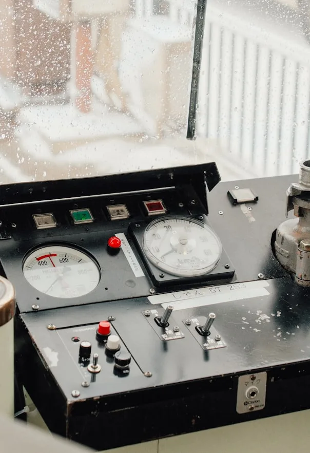 Industrial control console with gauges and machine controls.